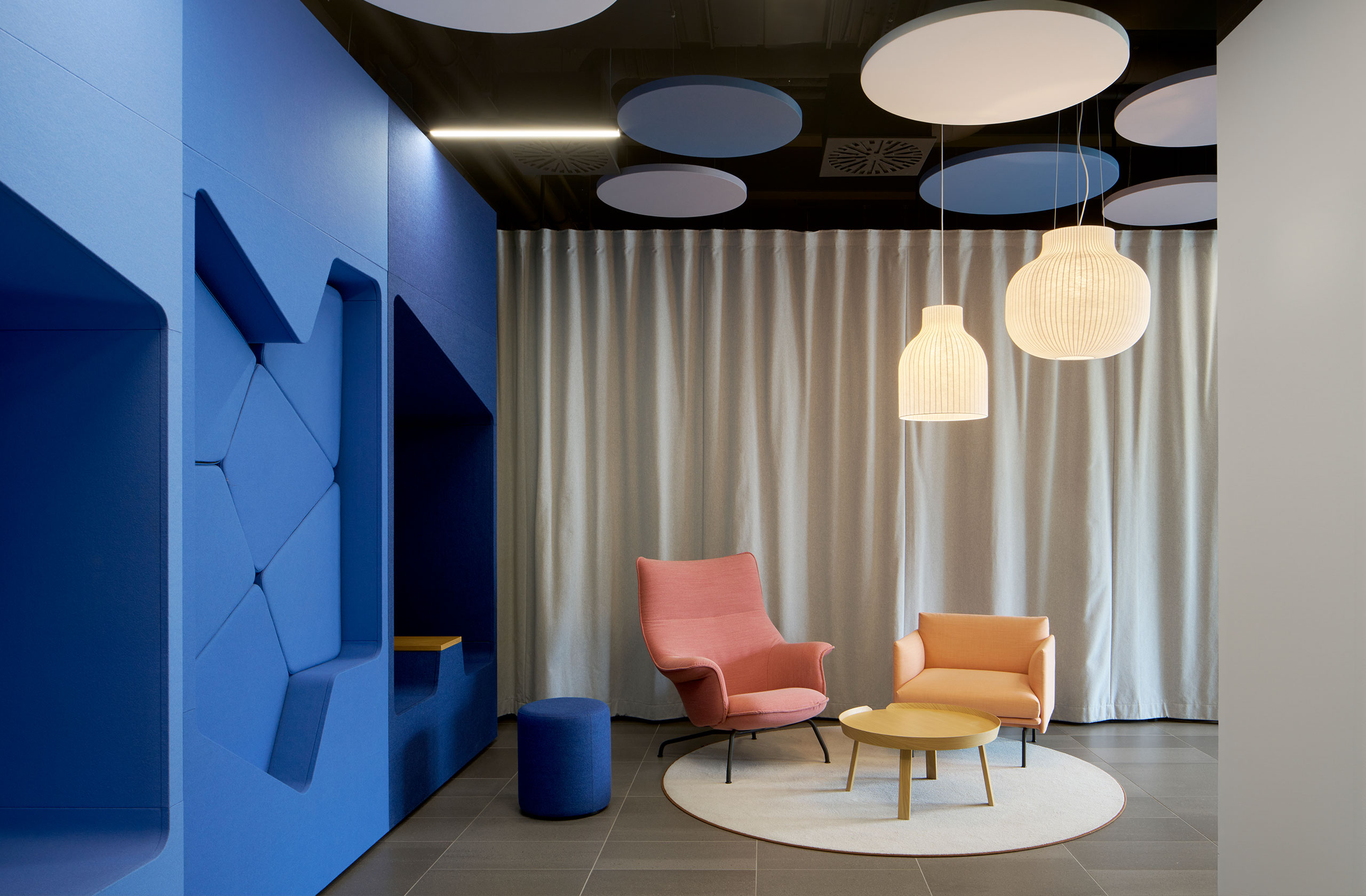 Aufenthaltsbereich mit blauer Akzentwand und Sitzgruppe